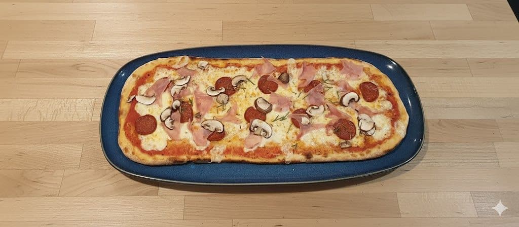 Zizzi Rustica pizza with chicken, pepperoni, ham, and mushrooms on a blue plate against a wooden counter, cropped to a square.
