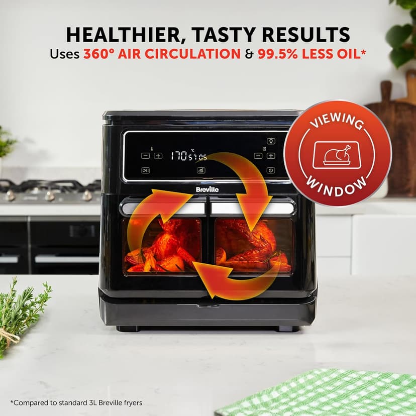 Breville Halo Flexi Digital Dual Air Fryer Oven on a kitchen countertop, showing 360° air circulation with arrows and roasted chicken inside through the viewing window. Text highlights healthier, tasty results using 99.5% less oil.